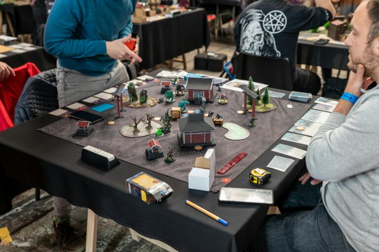 Players engaged in a tabletop miniature game tournament in Zagreb, showcasing strategy and teamwork.